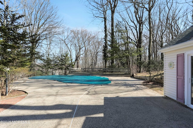 view of swimming pool with a fenced in pool and a patio