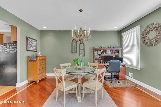 dining area featuring a notable chandelier and wood-type flooring