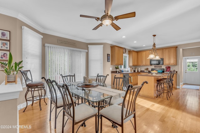 dining room featuring ceiling fan, ornamental molding, and light hardwood / wood-style flooring