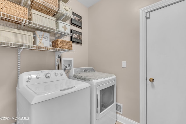 laundry area with washing machine and clothes dryer