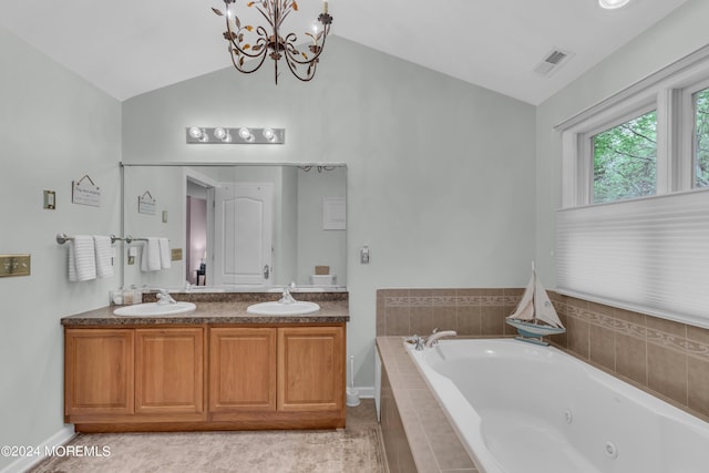 bathroom featuring vaulted ceiling, tiled bath, vanity, tile patterned floors, and a notable chandelier