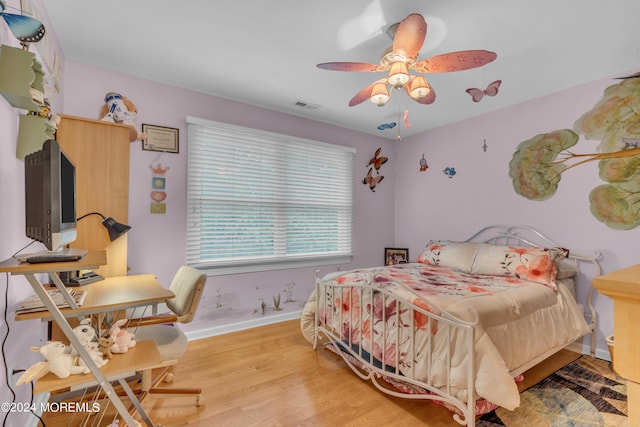 bedroom with ceiling fan and light wood-type flooring