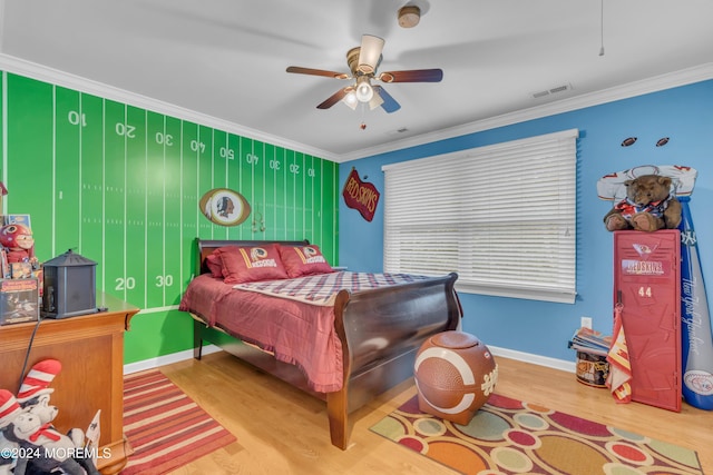 bedroom with ornamental molding, ceiling fan, and hardwood / wood-style floors