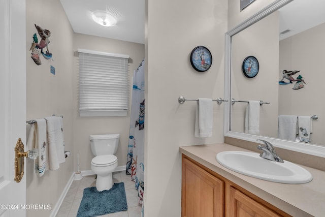 bathroom featuring tile patterned flooring, vanity, and toilet