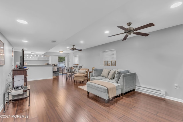 living room featuring ceiling fan, baseboard heating, and hardwood / wood-style flooring