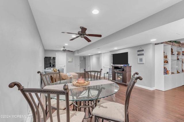 dining area featuring ceiling fan and hardwood / wood-style floors