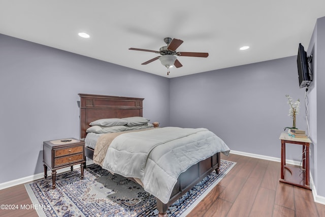 bedroom featuring ceiling fan and dark hardwood / wood-style floors