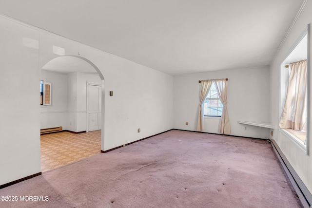 empty room with light colored carpet and a baseboard heating unit