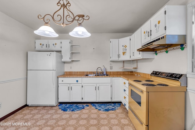 kitchen featuring white refrigerator, sink, white cabinetry, pendant lighting, and range with electric stovetop