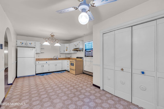 kitchen with white fridge, sink, white cabinets, stove, and ceiling fan with notable chandelier