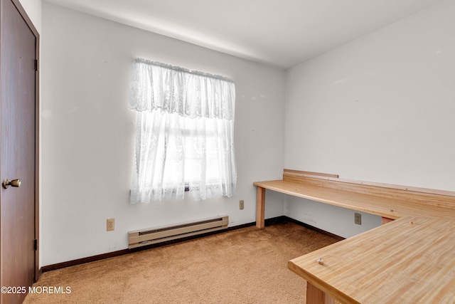 office space with a baseboard heating unit and carpet