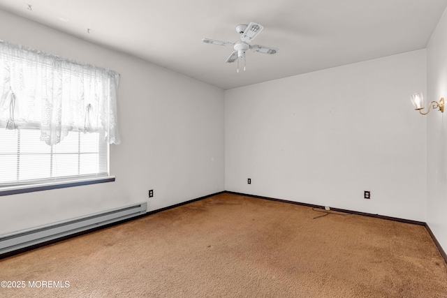 carpeted spare room with a baseboard heating unit and ceiling fan