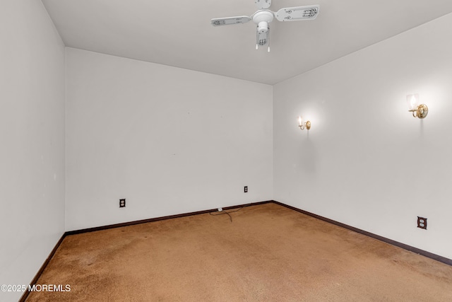 carpeted empty room featuring ceiling fan