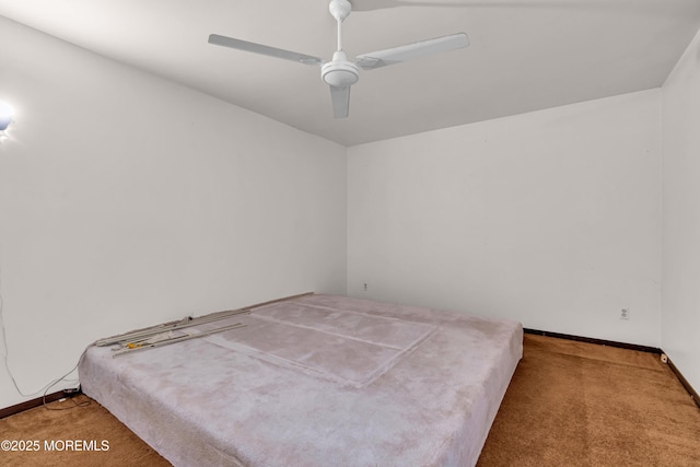 unfurnished bedroom featuring ceiling fan and carpet flooring