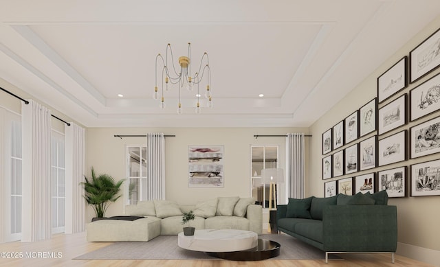 living room featuring a tray ceiling, wood-type flooring, and an inviting chandelier