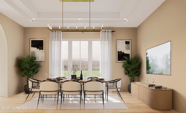 dining area featuring a raised ceiling and light wood-type flooring