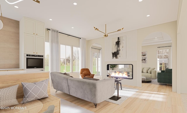 living room featuring light hardwood / wood-style flooring and an inviting chandelier