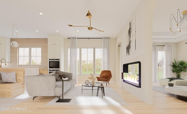 living room with light hardwood / wood-style flooring and a notable chandelier