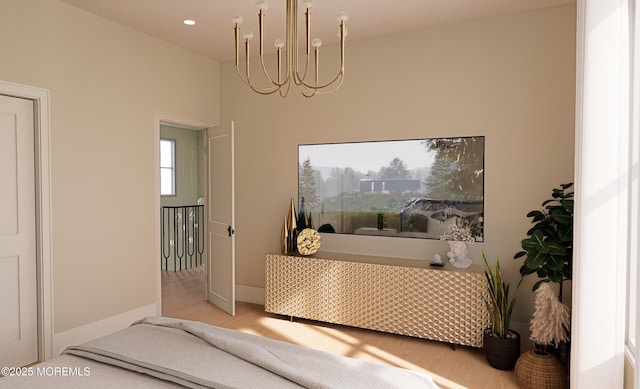 bedroom featuring light wood-type flooring and a chandelier