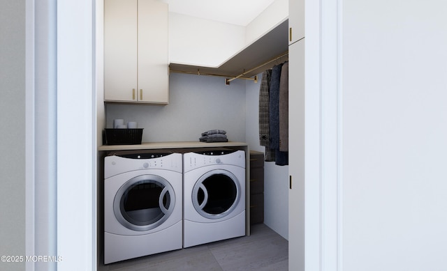 clothes washing area with washer and clothes dryer and cabinets