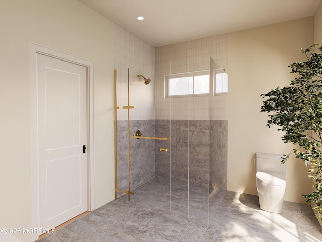 bathroom featuring toilet and a tile shower