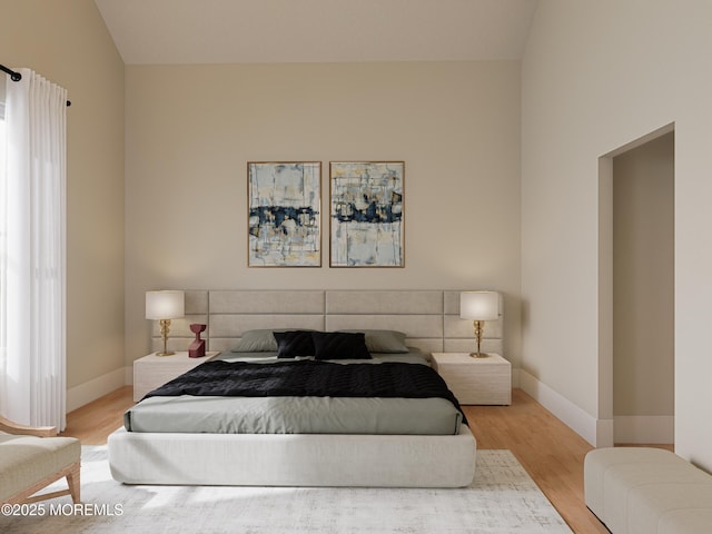 bedroom featuring light wood-type flooring and vaulted ceiling