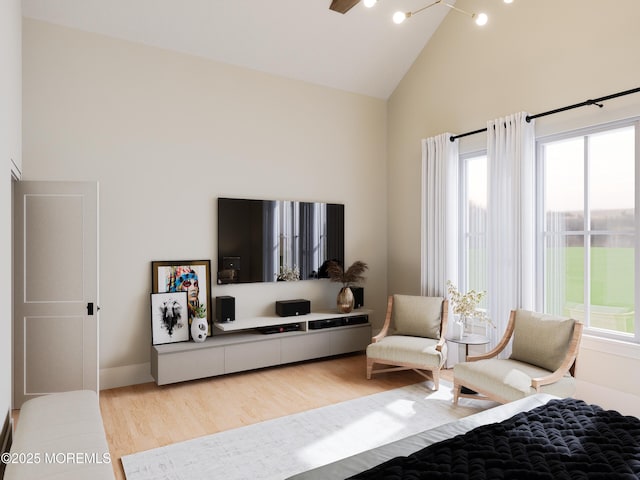 interior space with ceiling fan, high vaulted ceiling, and light hardwood / wood-style flooring