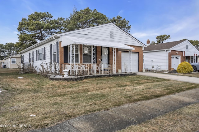 view of front facade featuring a garage, a front yard, and covered porch