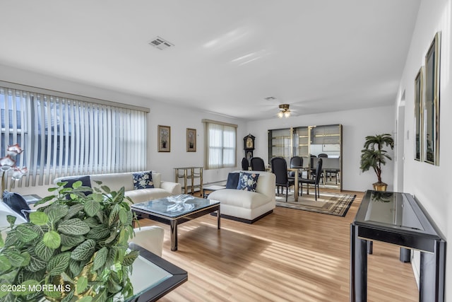 living room featuring hardwood / wood-style flooring and ceiling fan