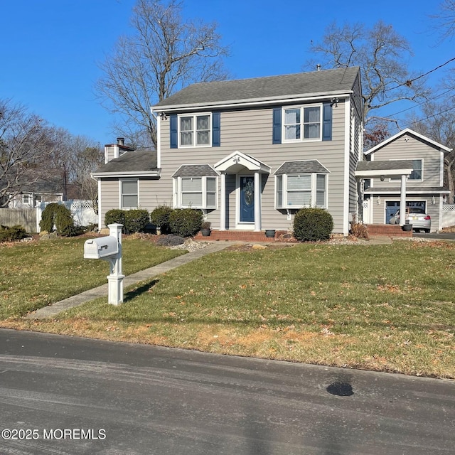 view of front of home featuring a garage and a front lawn