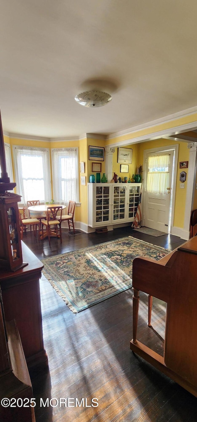 living room with ornamental molding and hardwood / wood-style flooring