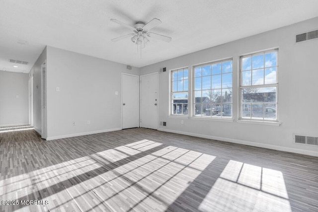 unfurnished room featuring ceiling fan and wood-type flooring