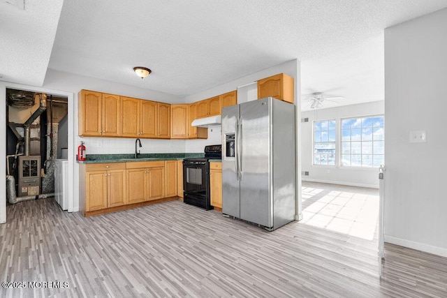 kitchen featuring a textured ceiling, ceiling fan, light hardwood / wood-style floors, stainless steel fridge, and electric range