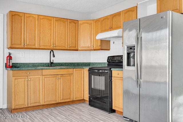 kitchen with sink, light hardwood / wood-style floors, decorative backsplash, stainless steel fridge, and black range with electric stovetop