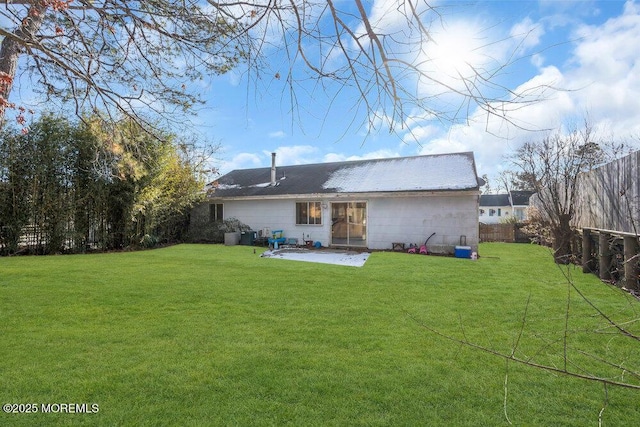 back of property featuring a patio and a lawn