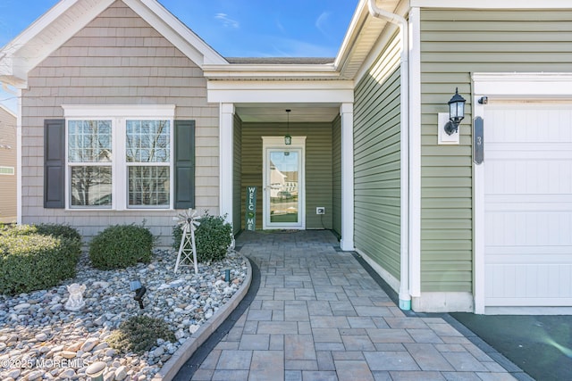 view of exterior entry featuring a garage