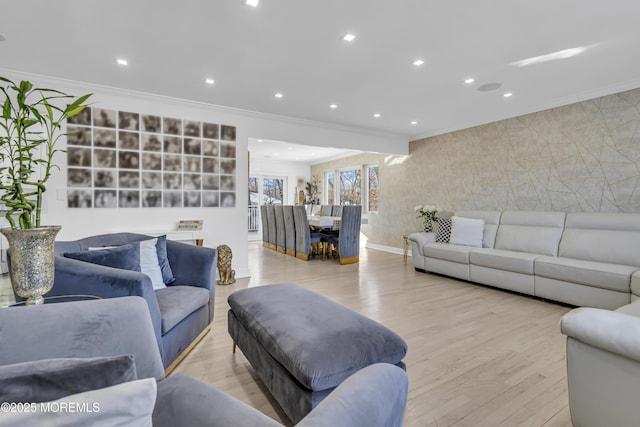 living room featuring crown molding and light hardwood / wood-style flooring