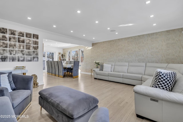 living room with ornamental molding and light hardwood / wood-style flooring