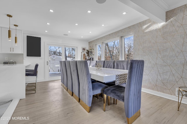 dining room with beamed ceiling, light hardwood / wood-style flooring, and ornamental molding