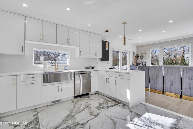 kitchen featuring sink, stainless steel dishwasher, crown molding, pendant lighting, and white cabinets