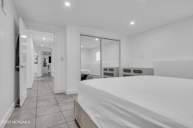 tiled bedroom featuring a closet