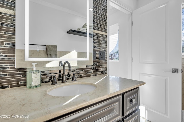 bathroom featuring vanity and tasteful backsplash