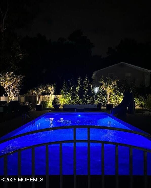 view of pool at night