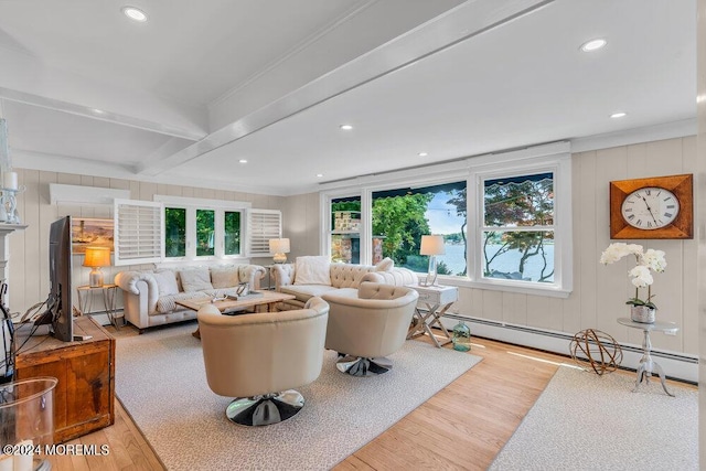 living room featuring a healthy amount of sunlight, light hardwood / wood-style floors, and beam ceiling