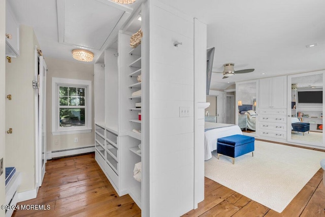 interior space with a baseboard radiator and light hardwood / wood-style floors