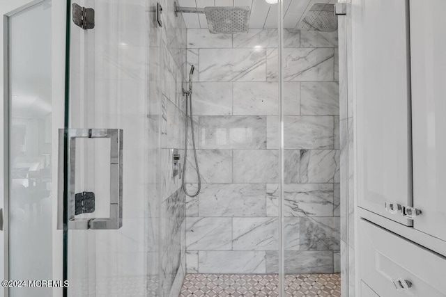 bathroom with a shower with door