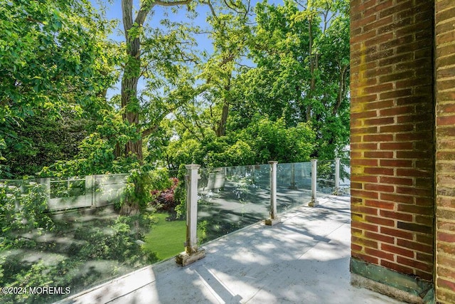 view of gate with a patio