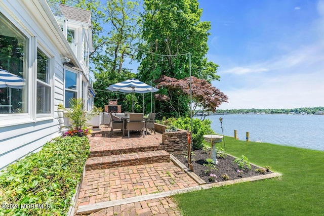 view of yard with a water view and a patio area