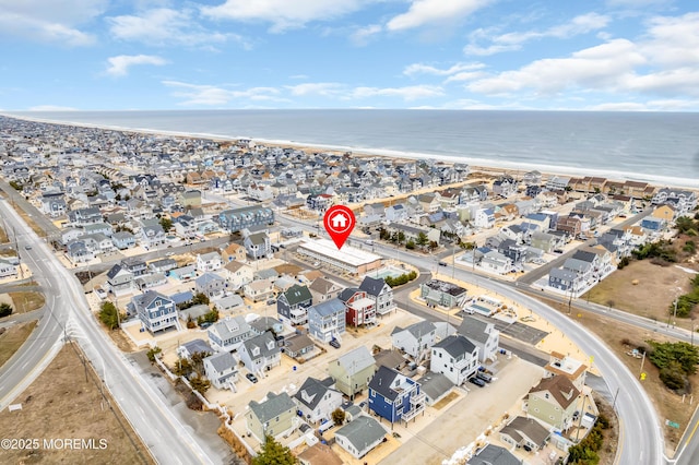 birds eye view of property with a beach view and a water view