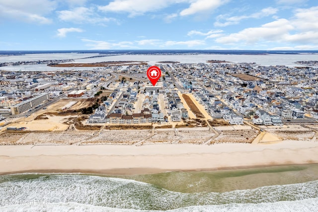 drone / aerial view with a view of the beach and a water view